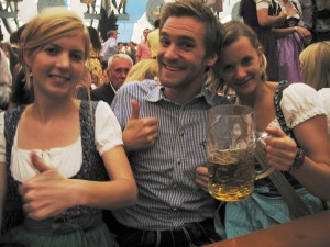 Friendly Bavarians in traditional costume with lederhosen and dindrls.